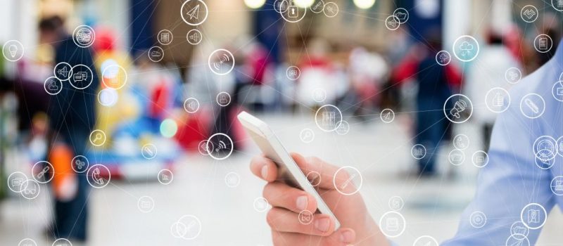 digital composite of hand holding smartphone with vignettes